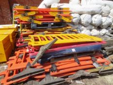 Approx forty various plastic pedestrian barriers