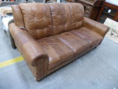 A large two tone Brown Leather Three Seat Settee on turned supports (est £50-£100)