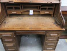 A large late 19th Century Oak Roll-Top Desk of typical form with 'S' shape tambour enclosing, a