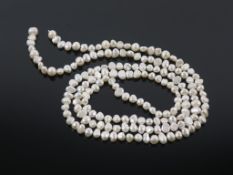 A String of Freshwater Pearls weighing approx. 54g and 110cm long (est £100-£150)