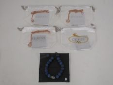 * Five items of new 'Guess' jewellery to include Pendants and Bracelets (four with drawstring