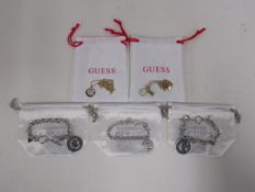 * Five items of new 'Guess' jewellery to include Bracelets, Pendant etc., each with branded white