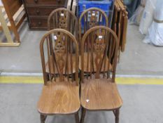 A set of four high wheelback single chairs with solid seats. (est. £20-£30)
