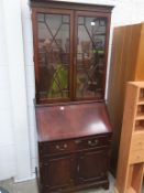 A reproduction Georgian style mahogany Bureau Bookcase with glazed astragal doors to the top, over a