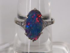 An Art Deco White Metal Opal Treble and Diamond Ring marked 'Gold' (size O) (est £120-£180)