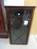 A 19th Century Mahogany Hanging Corner Display Cabinet with glazed astragal door enclosing shelves
