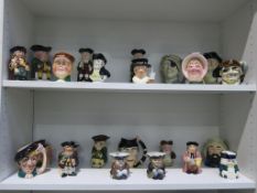 Two shelves to include a collection of twenty three Toby and Character Jugs including Oliver Twist