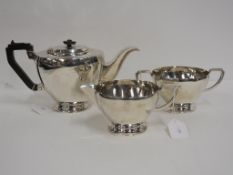 A matching three piece Silver Tea Set to include Tea Pot (Birmingham 1948) with 'Bakalite'