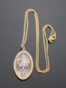 A 12ct Gold Pendant and Chain. The pendant is decorated around the edge with pearls (?) chain weight