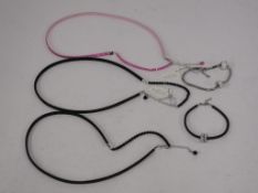 A total of three Swarovski Elements Necklaces and two Bracelets - three black, one pink and the