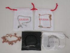 * Five items of new 'Guess' jewellery to include Pendants and Bracelets (four with drawstring