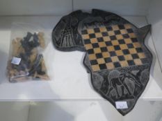A wooden hand carved Chess Set with the Wooden Board (Bog Oak) Forming an outline of the African