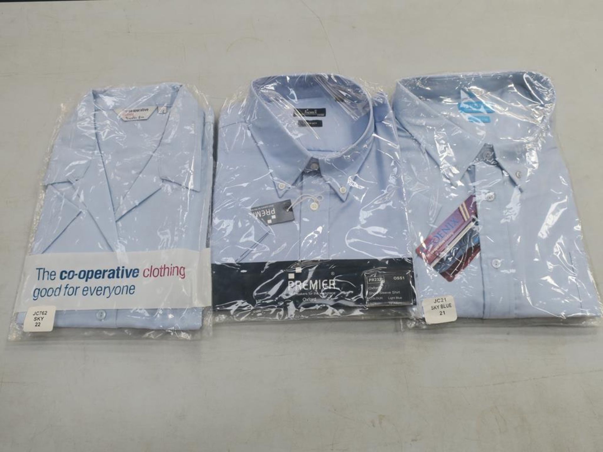 * A box containing Oxford style Light Blue and White Short Sleeve Shirts- sizes 15, 18, 19, 22inches