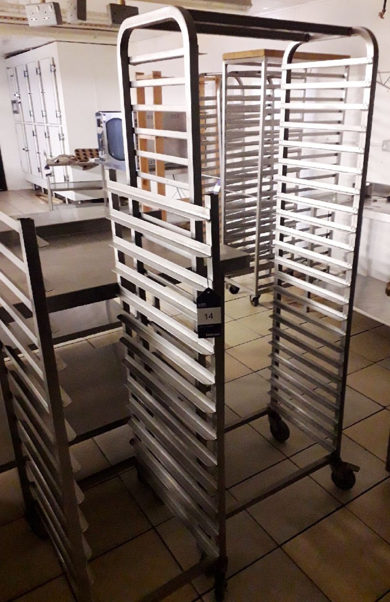 Two Mobile stainless steel tray racks (one rack has been cut down in height)