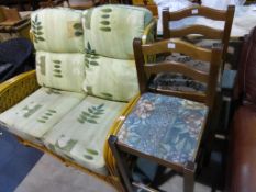 A Two Seater Cane Conservatory Settee with coloured fabric Cushions together with Two Cushioned