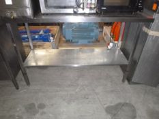 * A Stainless Steel Preparation Table with Splashback