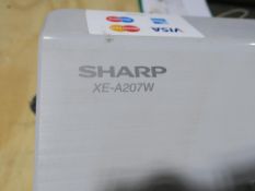 * A Sharp XE-A207W Electronic Till with manual