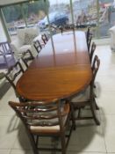 A Reproduction Mahogany Three Pedestal Dining Table with two Carver Ribbon Back Chairs and eight