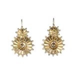 A pair of antique Victorian earrings in yellow gold each designed as a circular geometric motif with