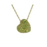 A jewelled peridot heart pendant in 18ct yellow gold designed as heart set with oval and round cut