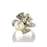 A pearl and diamond dress ring in white gold or platinum set with a large pearl measuring 9.2mm in
