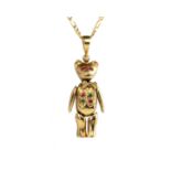 An antique novelty articulated gold teddy bear pendant and chain in 9ct yellow gold designed as a