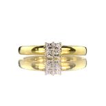 A diamond dress ring in 18ct yellow gold set with four princess cut diamonds creating the illusion