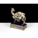 An unusual antique 19th Century jewelled Viennese Silver and natural pearl camel statue depicting