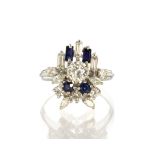 An Art Deco style diamond and sapphire dress ring in 18ct white gold set with a central round cut