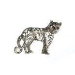 A jewelled silver novelty tiger / cat brooch with inset cabochon ruby eyes. Length 4.6cm / 1.75".