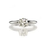 A solitaire diamond engagement ring in platinum set with a single round cut diamond weighing