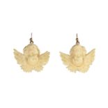A pair of antique carved ivory cherub earrings each carved in detail to depict a winged cherub.