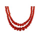 A fine Italian coral bead necklace in 18ct yellow gold designed as two strands of graduated round