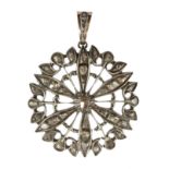 A large diamond flower pendant in gold and silver designed as a flower motif, set with a central