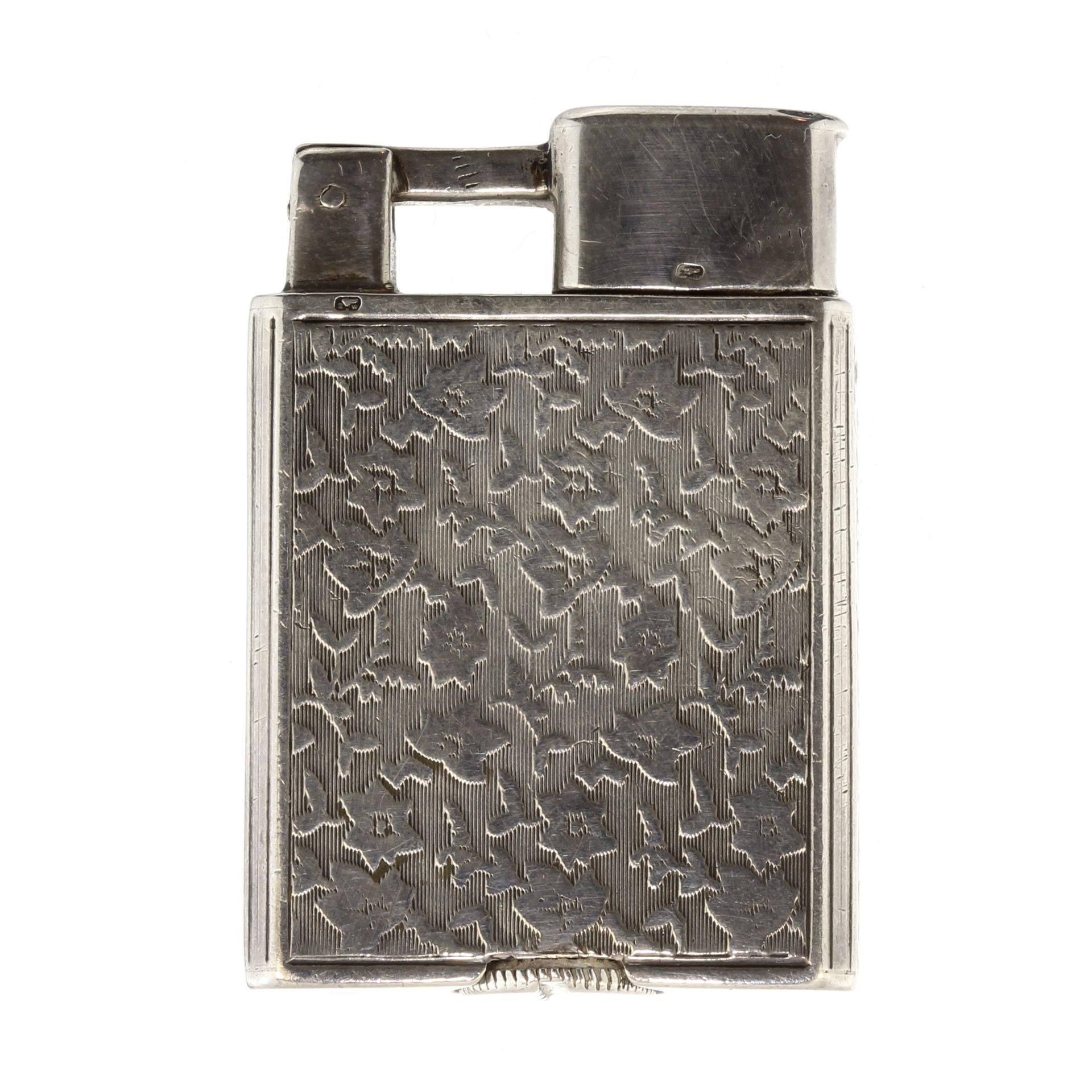 An antique Sterling silver cigarette lighter the rectangular body with flat chased floral decoration