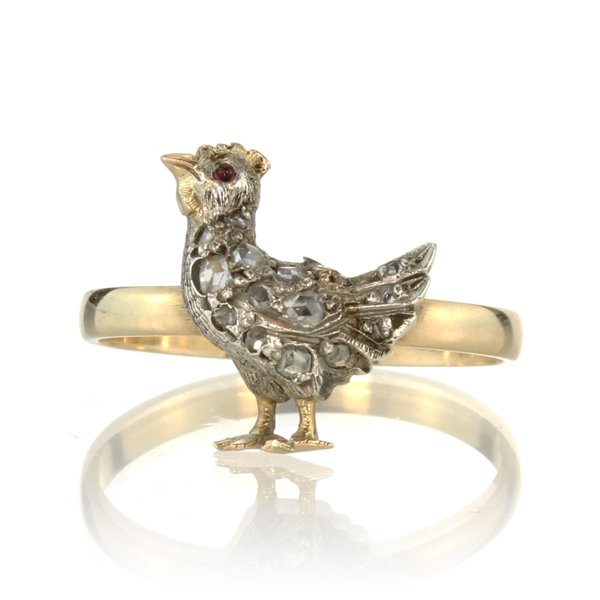 A jewelled ruby and diamond chicken / hen ring in 18ct yellow gold the hen depicted standing with