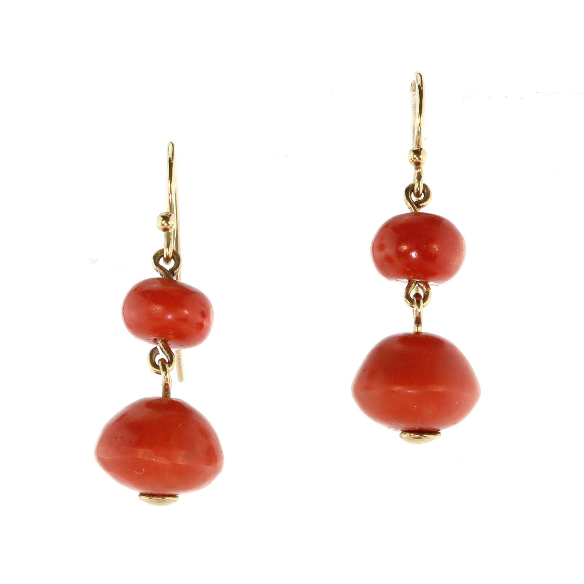 A pair of antique coral drop earrings with gold mounts each designed as two graduated coral beads