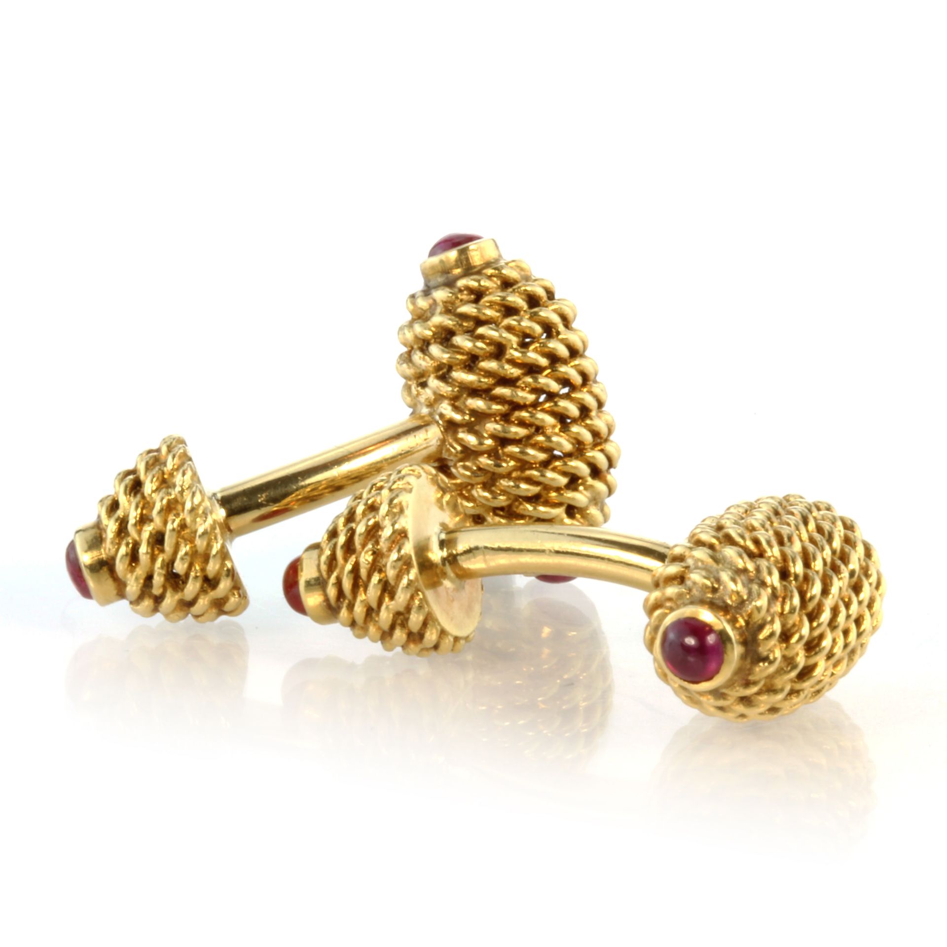 TIFFANY & CO A pair of ruby cufflinks in 18ct yellow gold by Tiffany & Co each designed as two links