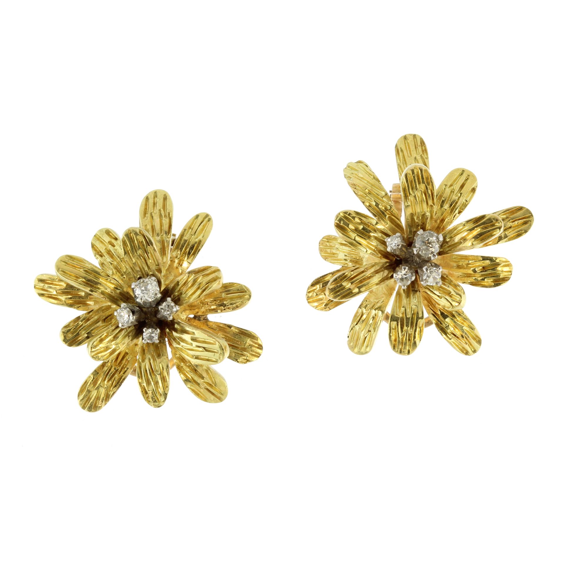 A pair of diamond flower clip earrings in 18ct yellow gold each designed as a flower with textured