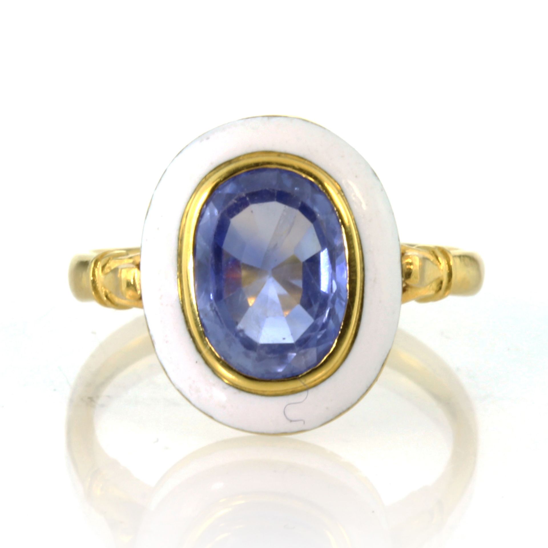 An antique unheated Ceylon sapphire and enamel dress ring in high carat yellow gold set with a