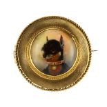 An antique Essex crystal / reverse carved intaglio dog brooch in high carat yellow gold set with a