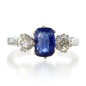 An antique sapphire and diamond three stone dress ring in 18ct gold and platinum, set with a central