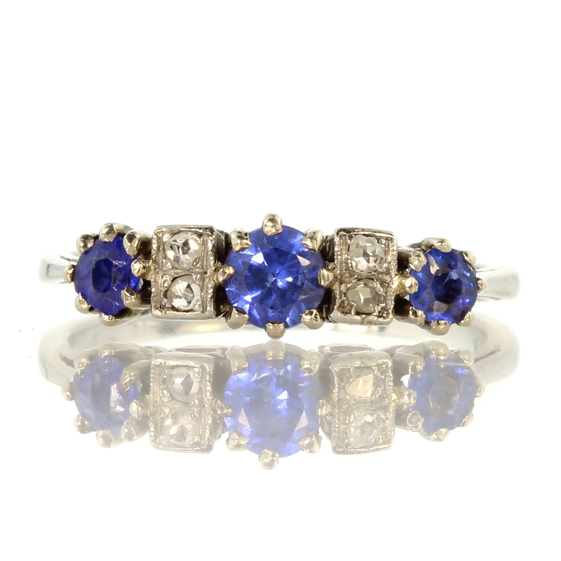 An antique sapphire and diamond dress ring circa 1910, in white gold or platinum, set with three