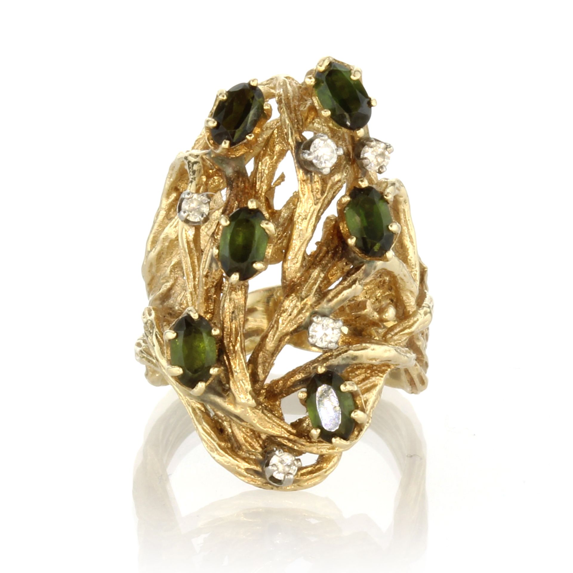 A vintage green tourmaline and diamond dress ring in 18ct yellow gold the stones set across a