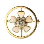 An opal and diamond flower brooch in high carat yellow gold set with a central round cut diamond