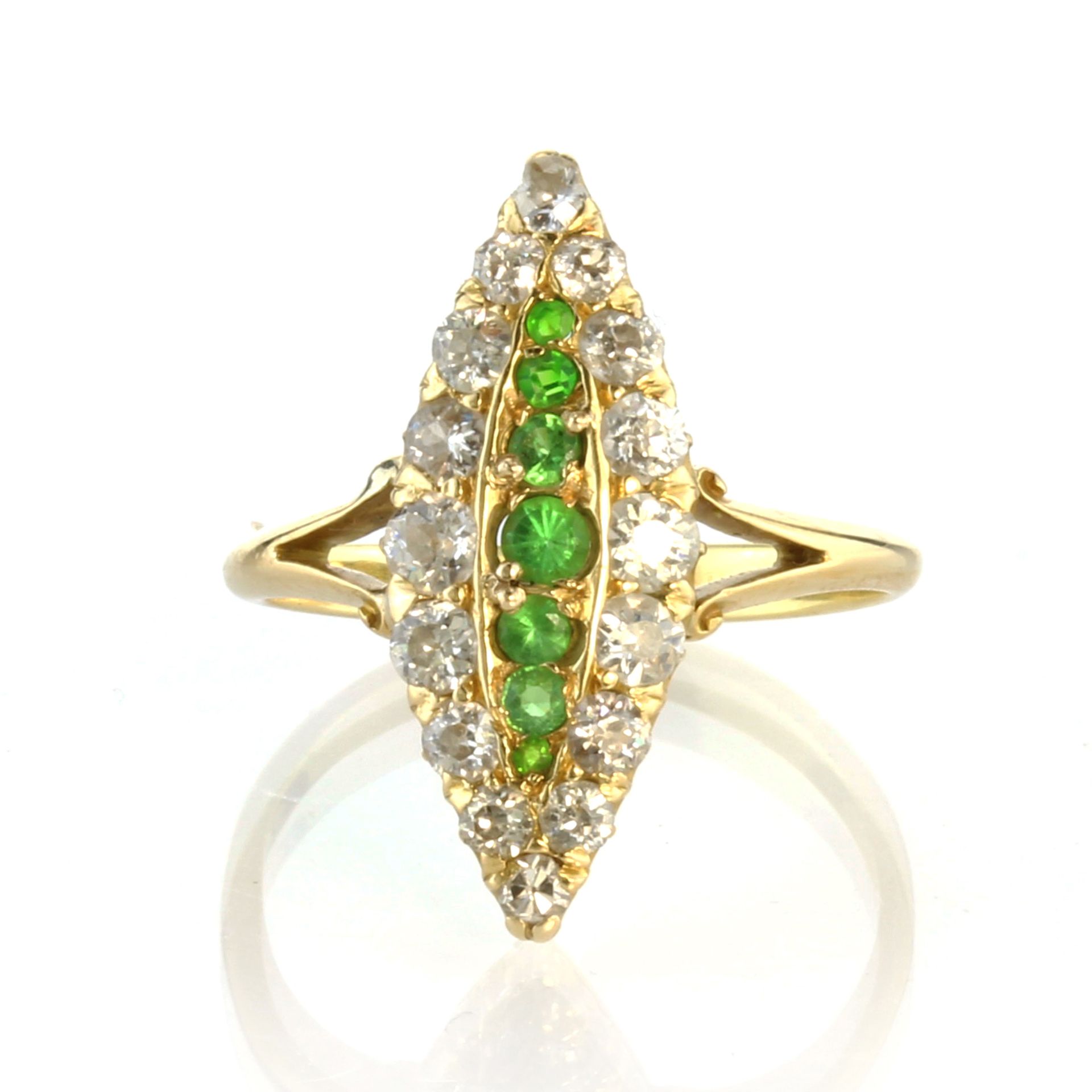 An antique demantoid garnet and diamond dress ring in 18ct yellow gold set with seven graduated