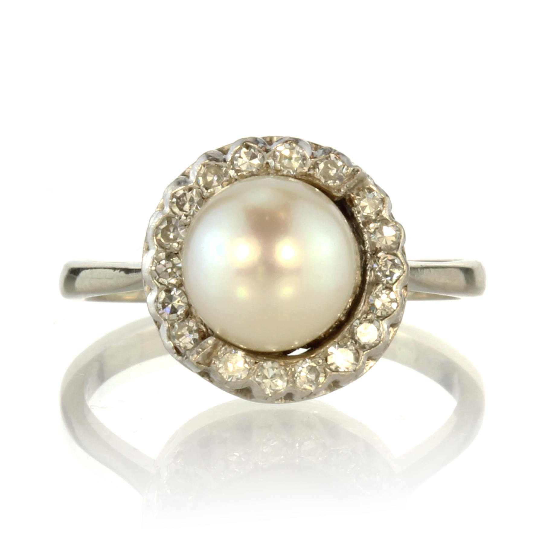 A pearl and diamond cluster dress ring in 18ct white gold set with a central pearl of 8.2mm in