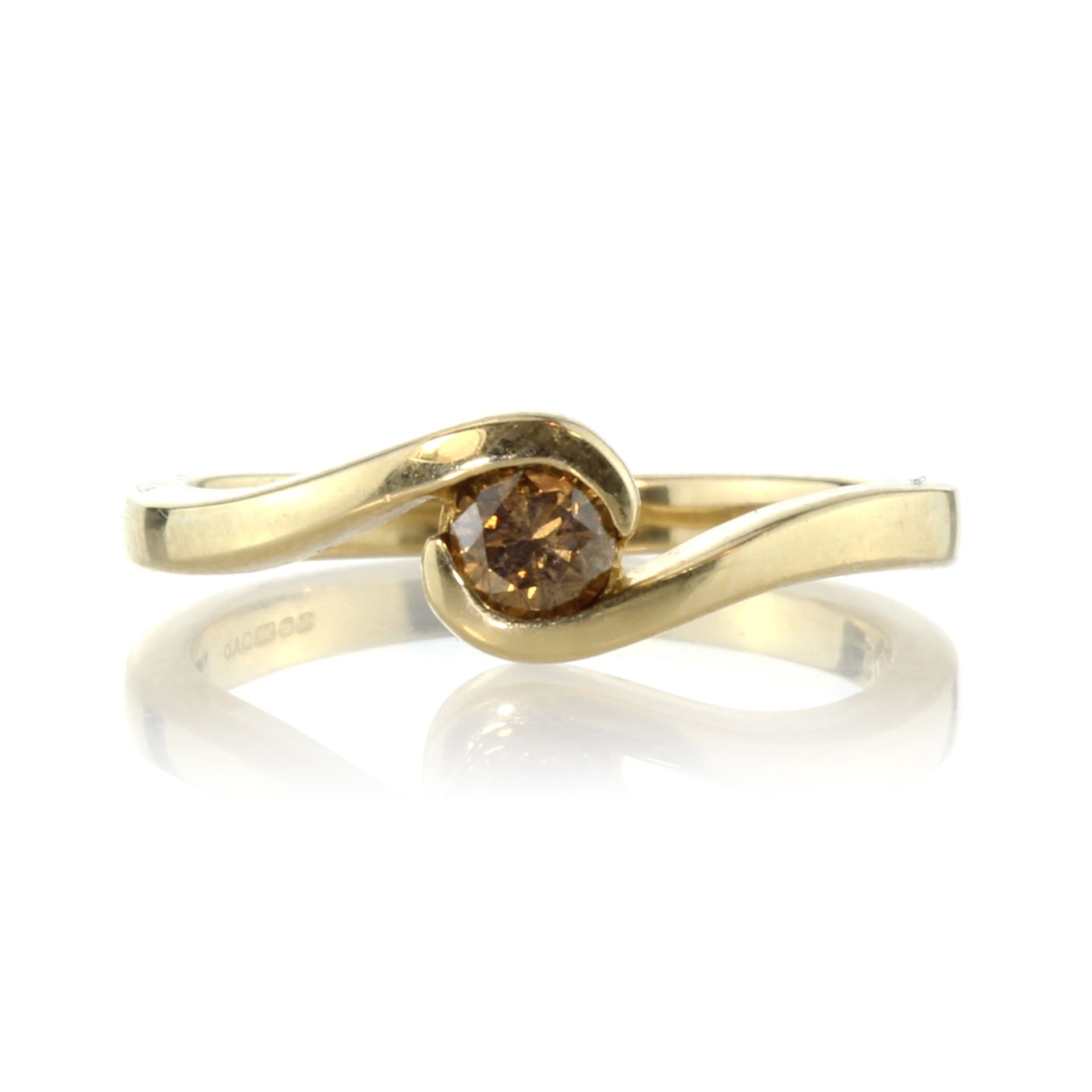 A champagne diamond dress ring in 9ct yellow gold set with a single round cut dark yellowish