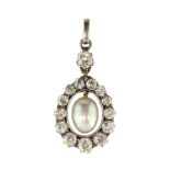 An antique natural saltwater pearl and diamond pendant in gold and silver, set with a central