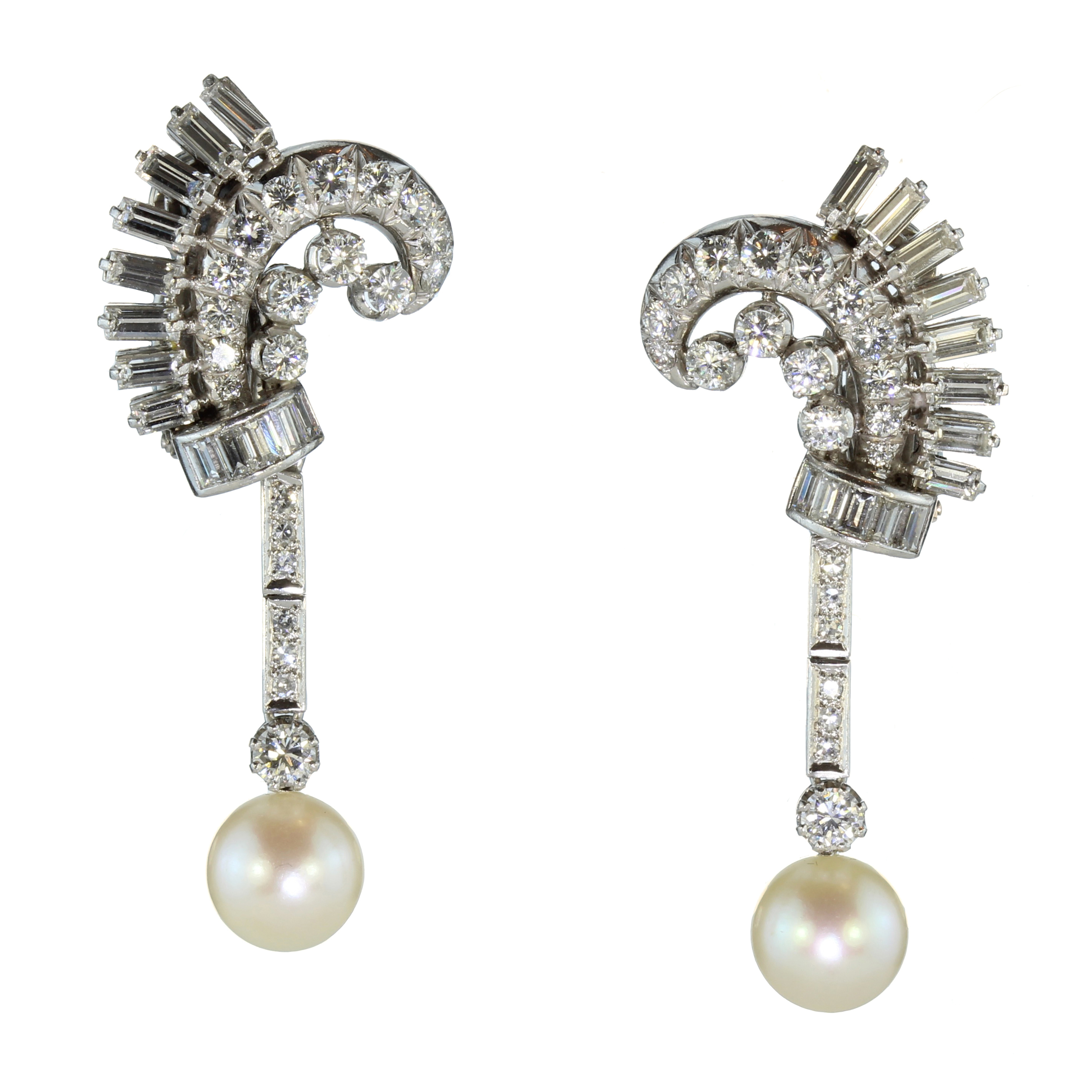 A pair of French diamond and pearl cocktail earrings in platinum each designed as a scrolling